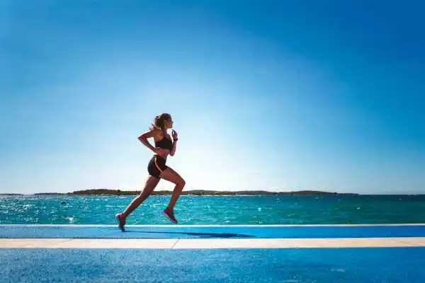 Woman running showing strong leg muscle Westminster